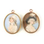A PAIR OF 19TH CENTURY OVAL PORTRAITS ON IVORY depicting young ladies, mounted in gilt metal