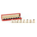 A SET OF EIGHT CASED CARTIER STERLING SILVER SALTS of bulbous form with faceted sides and screw
