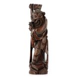 A 19TH CENTURY CHINESE HARDWOOD CARVED FIGURE OF A MAN decorated with brass inlays 28cm high