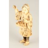 A 19TH CENTURY JAPANESE CARVED IVORY OKIMONO in bamboo decorated costume and head-dress 8.5cm high