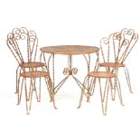 A 19TH CENTURY REGENCY STYLE WROUGHT IRON SUITE OF GARDEN FURNITURE COMPRISING A CIRCULAR TABLE