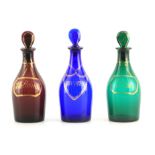 A MATCHED SET OF THREE LATE GEORGIAN COLOURED SPIRIT DECANTERS with gilt work labels for Rum,