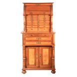 A LATE 19TH CENTURY WALNUT DENTIST'S CABINET the top section with rounded front tambour top above