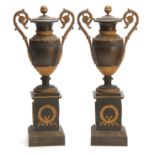 A PAIR OF REGENCY BRONZE AND ORMOLU ADAM STYLE URNS/CANDLEHOLDERS having reversible tops and