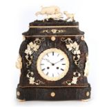 A LATE 19TH CENTURY BLACK FOREST ANTLER AND IVORY MANTEL CLOCK the shaped case, veneered in