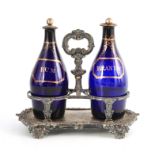 TWO EARLY 19TH CENTURY BRISTOL BLUE DECANTERS FOR RUM AND BRANDY mounted in an old Sheffield plate