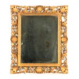 AN EARLY 19TH CENTURY CARVED GILT GESSO FLORENTINE MIRROR with finely carved leaf work frame and