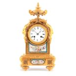 A 19TH CENTURY FRENCH ORMOLU AND PORCELAIN PANELLED MANTEL CLOCK the case surmounted by an urn