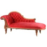 HOWARD AND SONS A 19TH CENTURY WALNUT FRAMED CHAISE LONGUE with carved leaf work decoration,