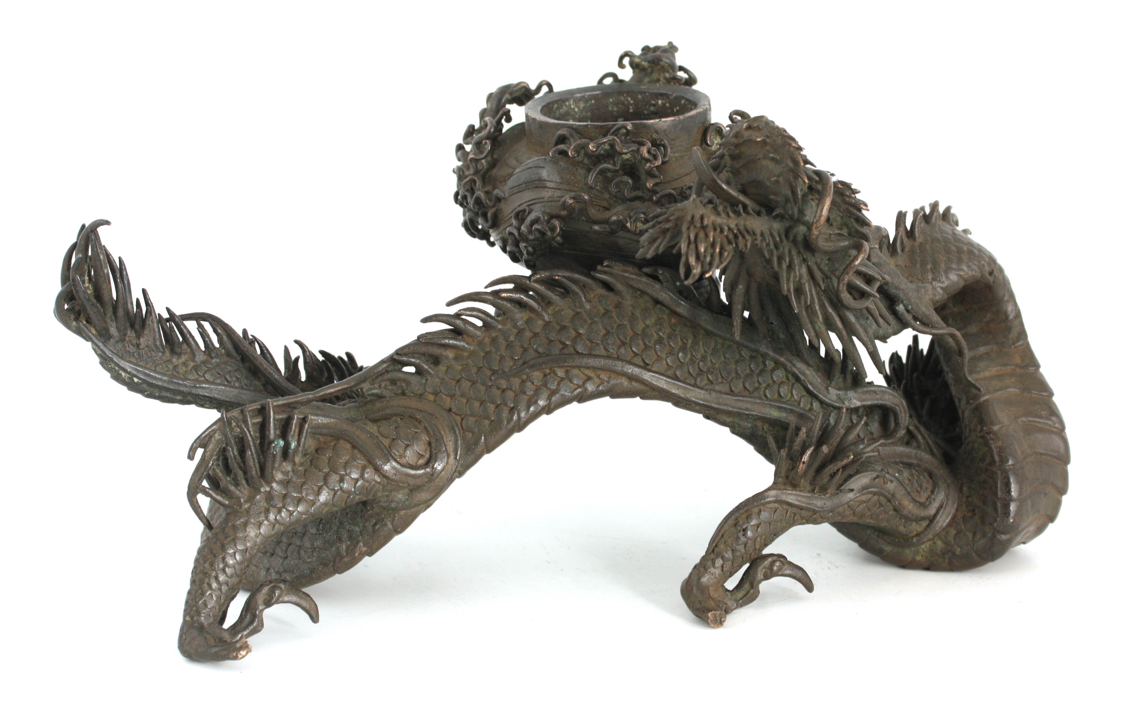 A MEIJI PERIOD JAPANESE BRONZE INCENSE BURNER modelled as a slender dragon holding a vessel 26cm