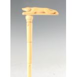 A LATE 19TH CENTURY IVORY SECTIONAL WALKING STICK with carved dog-shaped handle and simulated