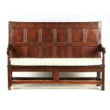 A LATE 17TH CENTURY JOINED OAK SETTLE INITIALED I.F. AND DATED 1692 having panelled back with carved