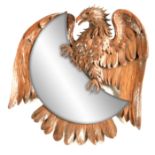 A LATE 19TH CENTURY BLACK FOREST CARVED MIRROR realistically modelled as an eagle with amber glass