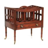 AN EARLY 20TH CENTURY MAHOGANY CANTERBURY with four divisions to the top having a central cutout