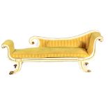 A REGENCY CREAM PAINTED CHAISE LONGUE decorated with gilt edging and brass mounts, having an