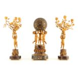 A LATE 19TH CENTURY ORMOLU AND MARBLE FIGURAL CLOCK GARNITURE modelled as three cherubs raised on an