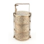 AN EARLY 20TH CENTURY ORIENTAL SILVER SPICE TOWER having three circular boxes with foliate relief