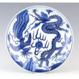 A CHINESE BLUE AND WHITE PORCELAIN CHARGER decorated with dragons - signed to reverse with six-