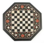 A 19TH CENTURY PIETRA DURA INLAID OCTAGONAL TABLE TOP decorated with mother of pearl chess board