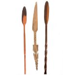 THREE 19TH CENTURY AFRICAN HARDWOOD SPEARS one with mask head and barley twist stem 126cm and