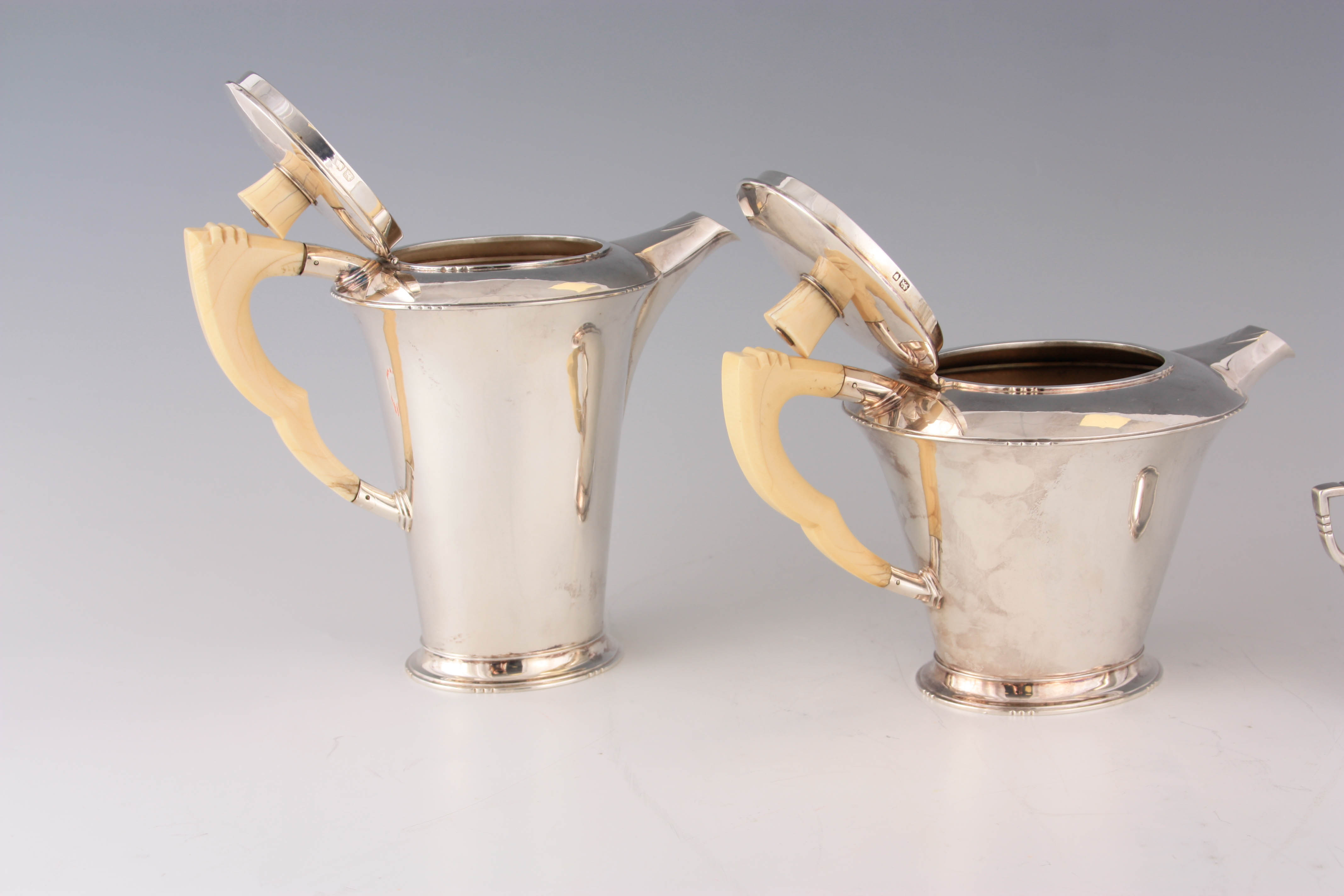 A GEORGE VI FOUR PIECE SILVER TEA AND COFFEE SERVICE OF ART DECO DESIGN the plain tapering bodies - Image 2 of 8