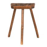 A 19TH CENTURY CUTLERS STOOL with Elm seat raised on ring turned legs 59cm high 39cm wide