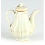 AN EARLY ANTIQUE CHINESE CELEDON MINATURE TEAPOT decorated with leaf designs 9cm high