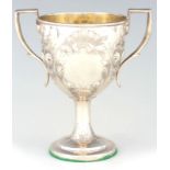 A GEORGE III IRISH SILVER TWO HANDLED EMBOSSED LOVING CUP with floral engraved conical body with