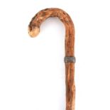 A CONTINENTAL KNARLED ROOT WOOD WALKING STICK with basketweave silver metal mounted shaft and