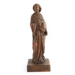 A 16TH CENTURY CARVED OAK FIGURE OF A SAINT holding a bible, mounted on a square plinth base 32.