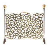 A STYLISH 1960's CAST IRON AND GILT BRONZE FIRE SCREEN of naturalistic design, standing on arched