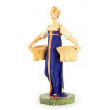 A RUSSIAN PORCELAIN FIGURE depicting a young female carrying baskets mounted on a circular base 23cm