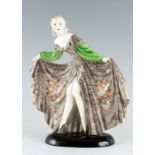A STYLISH GOLDSCHEIDER STANDING FIGURE OF A YOUNG LADY in an elaborate swept dress 32cm high 27cm