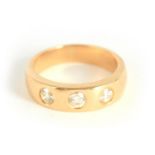 A GENTLEMAN'S 18CT YELLOW GOLD AND DIAMOND GYPSY SET RING having three flush set diamonds app. 0.