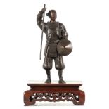 A MEIJI PERIOD JAPANESE PATINATED BRONZE SCULPTURE modelled as a Samurai mounted on a pierced and