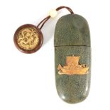 A JAPANESE MEIJI PERIOD SHAGREEN COVERED SPECTACLE CASE WITH ATTACHED NETSUKE the case with