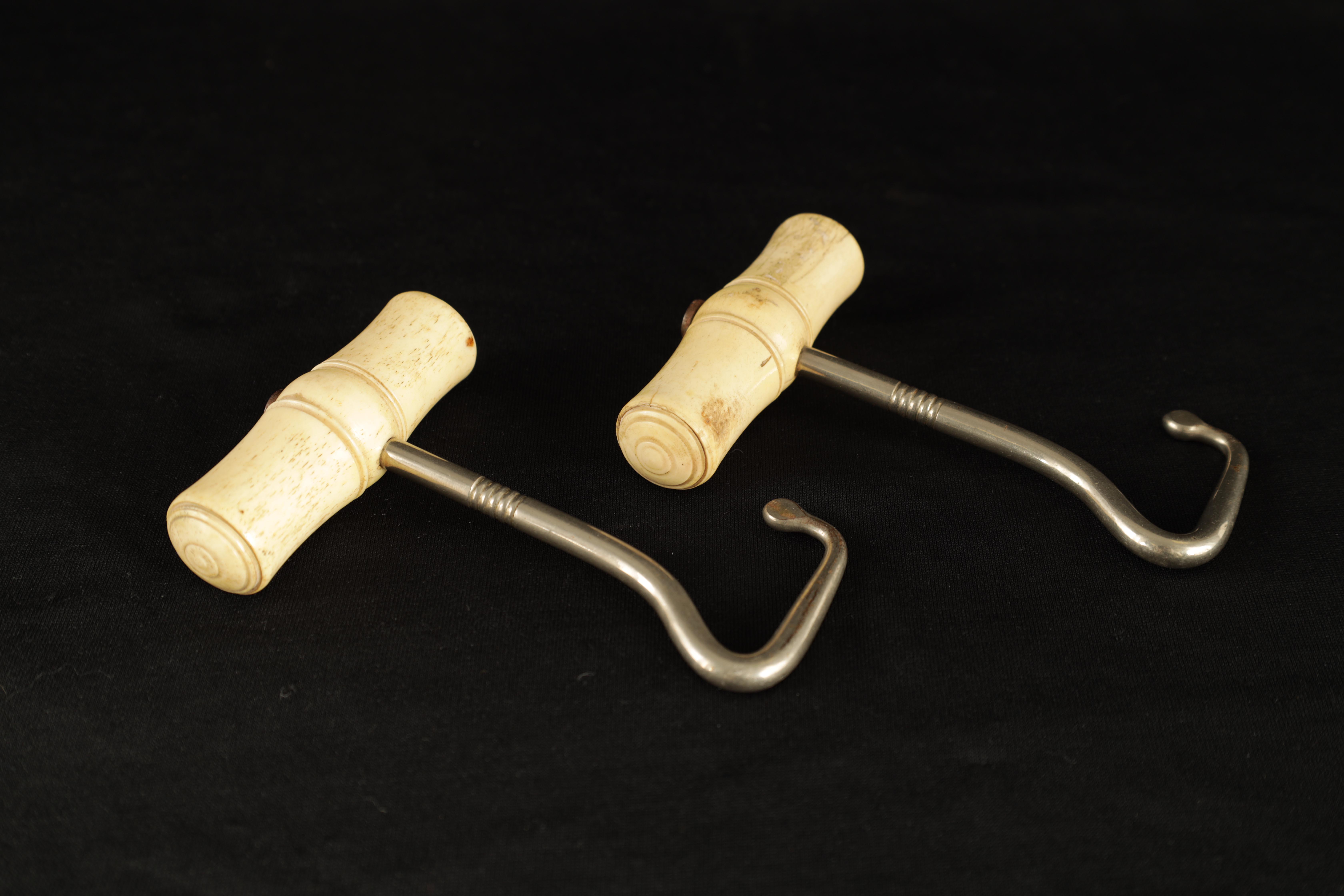 A PAIR OF LATE 19TH CENTURY BONE AND SILVERED METAL BOOTJACKS with turned handles 12.5cm overall - Image 2 of 3