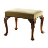 A GEORGE II WALNUT STOOL with upholstered top raised on cabriole legs with pad feet 60cm wide 45cm