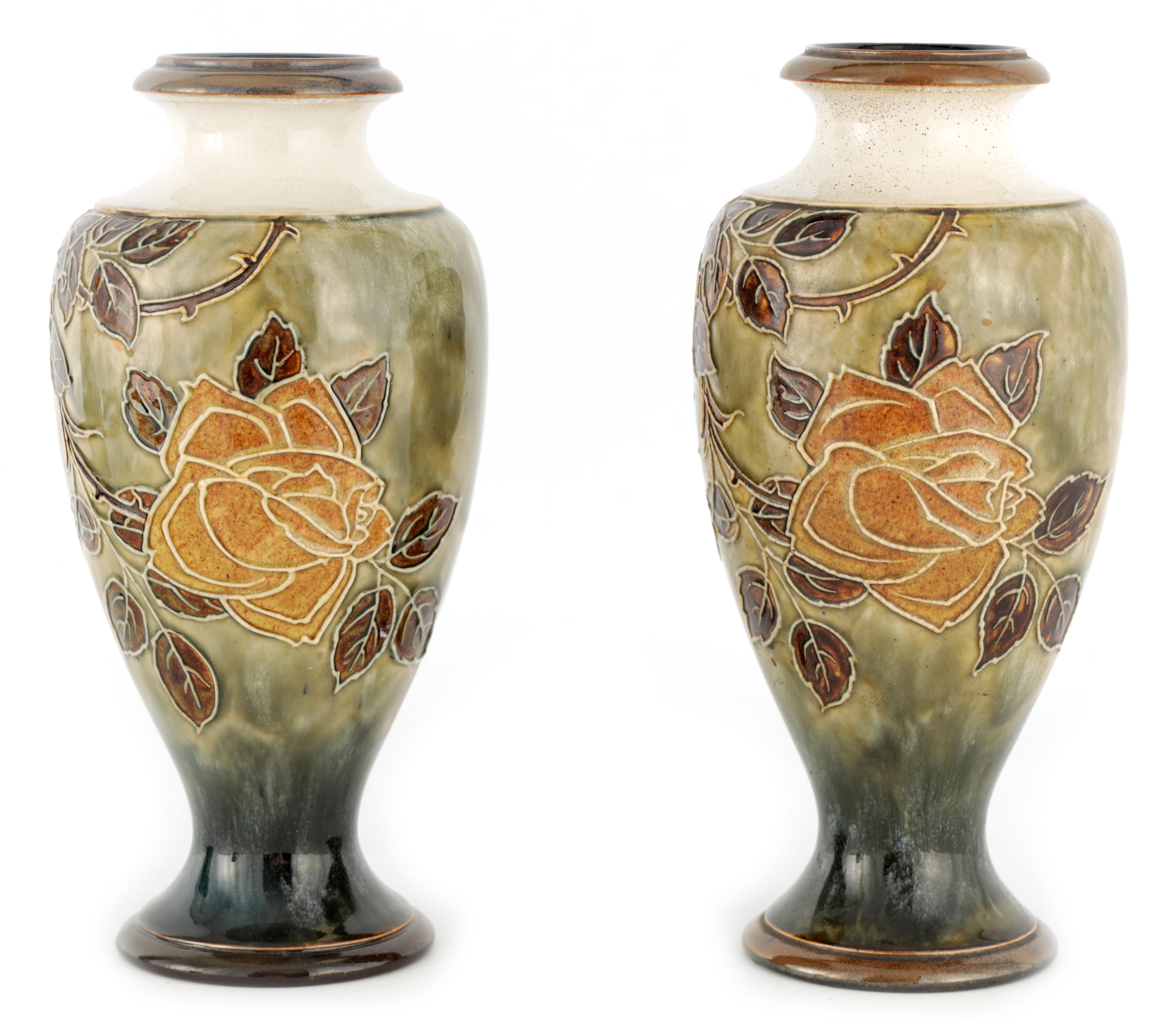 A PAIR OF ROYAL DOULTON INVERTED BALUSTER TALL VASES DESIGNED BY FLORRIE JONES tube lined and