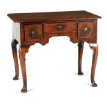 A QUEEN ANNE FIGURED WALNUT LOWBOY OF GOOD COLOUR AND PATINA the quarter veneered top with herring-