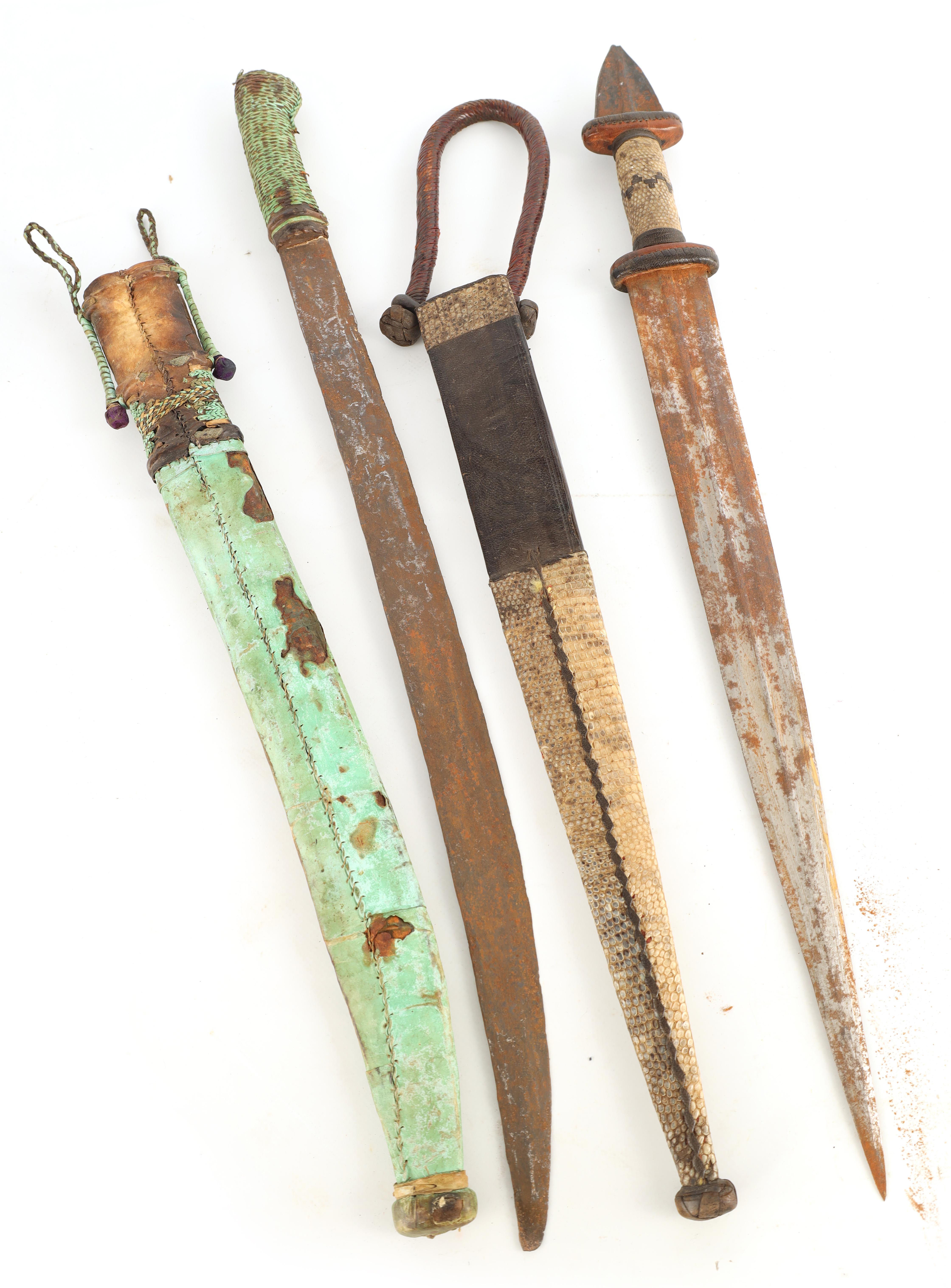 TWO 19TH CENTURY AFRICAN DAGGERS one with a snakeskin handle and scabbard having a tapering steel