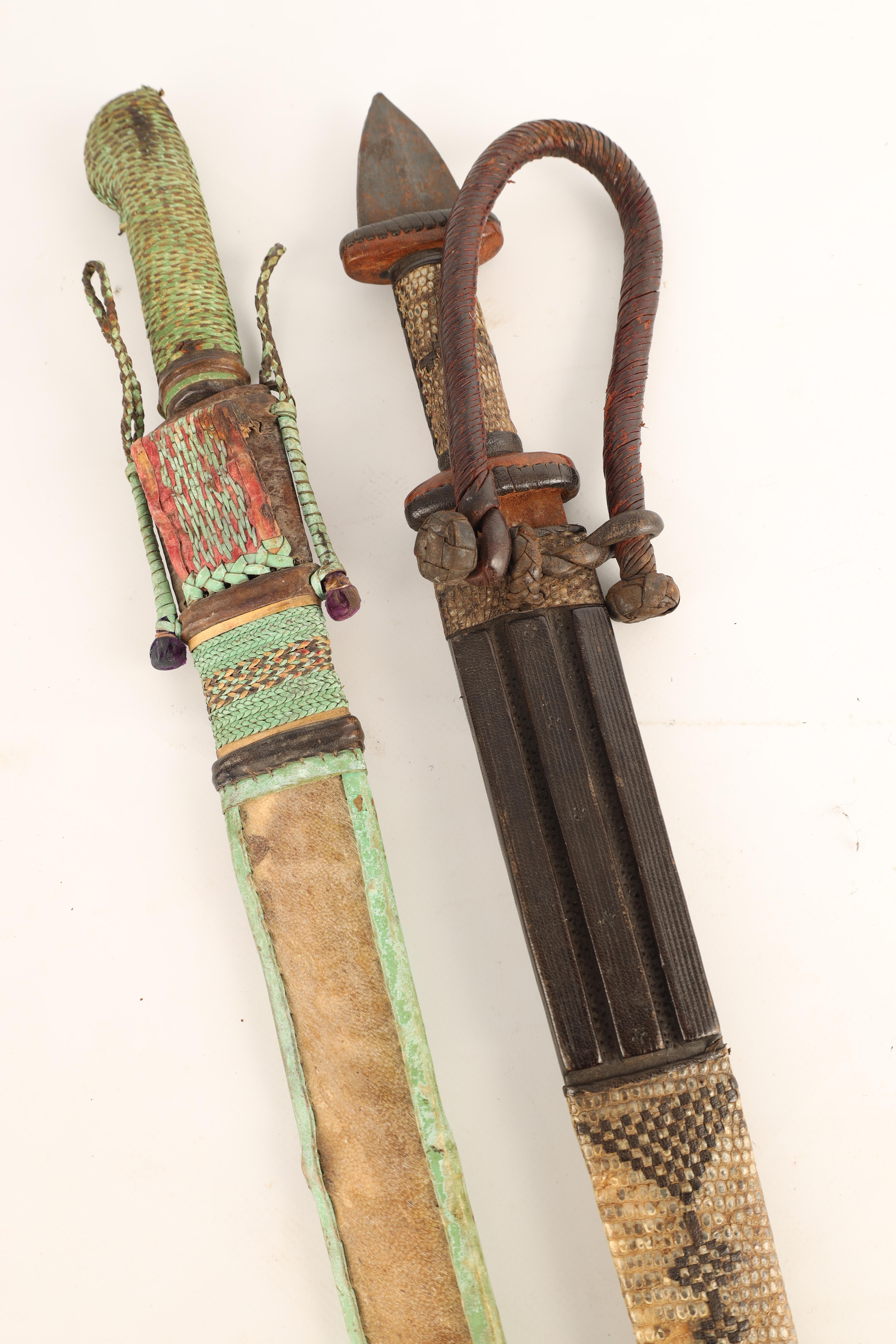 TWO 19TH CENTURY AFRICAN DAGGERS one with a snakeskin handle and scabbard having a tapering steel - Image 5 of 7