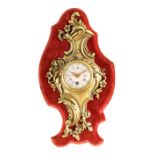 A LATE 19TH CENTURY FRENCH MINIATURE CARTEL CLOCK the rococo style brass case mounted on a velvet-