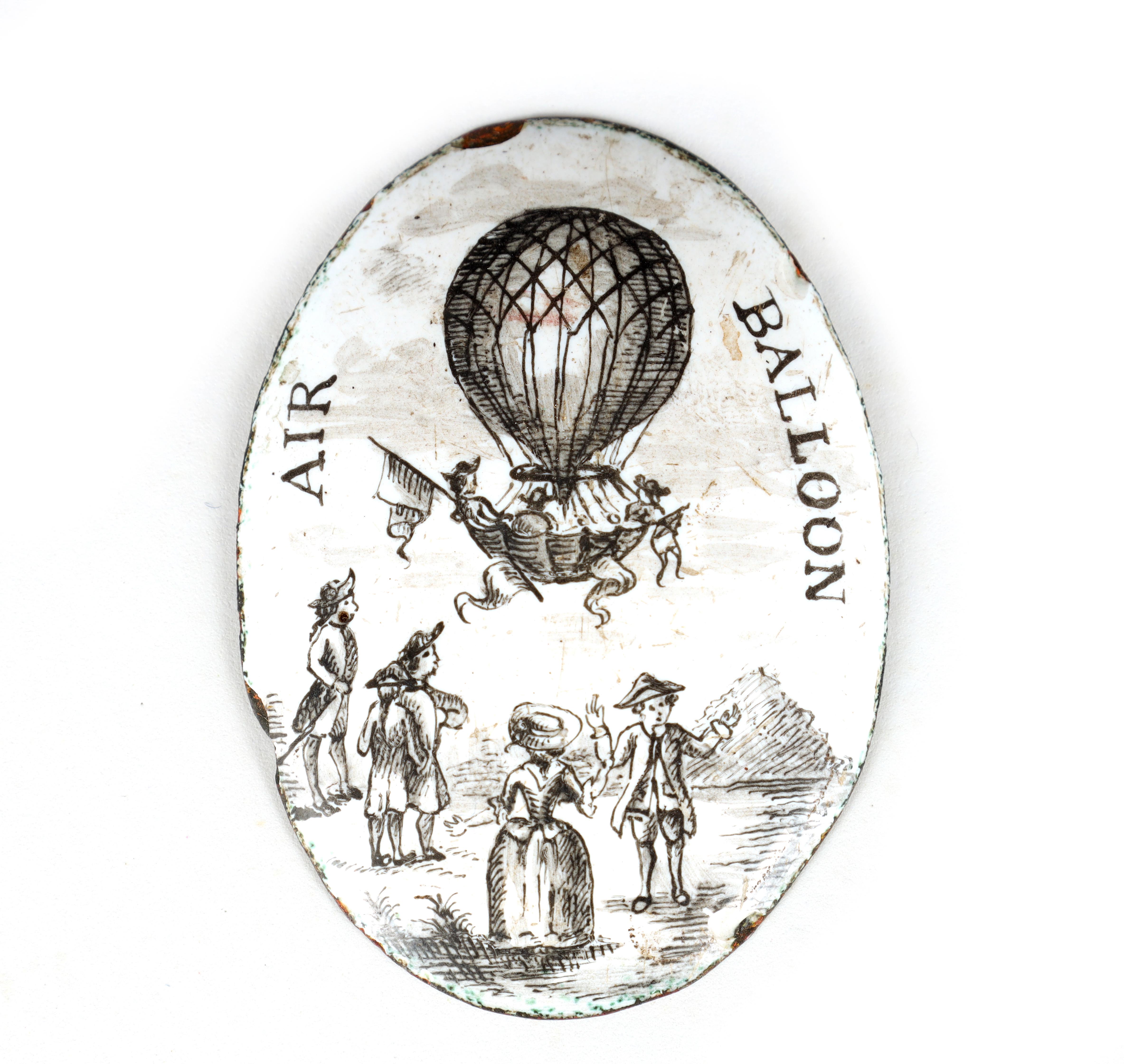 A RARE 18TH CENTURY BATTERSEA ENAMEL ON COPPER OVAL BADGE DEPICITING AN AIR BALLOONING SCENE 4.5cm
