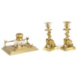 A PAIR OF ORIENTAL STYLE BRASS CANDLESTICKS with crouching dragon and shaped bases 14cm high