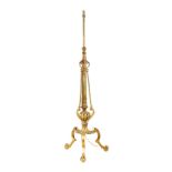 A LATE 19TH CENTURY REGENCY STYLE BRASS STANDARD LAMP having tapering leaf cast adjustable stem with