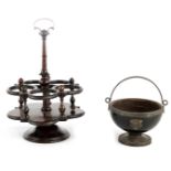 A LATE GEORGIAN ROSEWOOD REVOLVING FIVE BOTTLE TABLE CRUET STAND with circular carved edge foot,