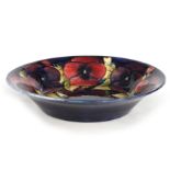 A 1930S/40S MOORCROFT LARGE SHALLOW DISH WITH EVERTED RIM decorated in the big pansy pattern on a