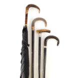 A COLLECTION OF THREE WALKING CANES AND A PARASOL three horn handled with ebonised sticks and a