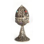 A 19TH CENTURY RUSSIAN SILVER FILIGREE EGG ON STAND decorated in segments of fine swirling decorated